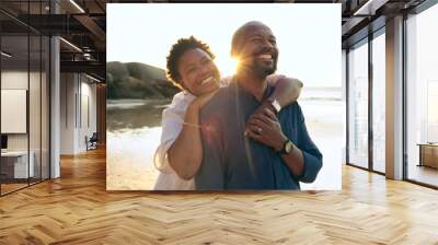 Couple, hug and happy on beach with love, bonding and sunset for holiday, vacation and relationship. Black people, man or woman with embrace, smile and romance by ocean or sea for travel or adventure Wall mural