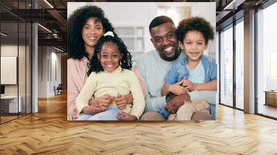 Happy, love and portrait of a black family in the living room sitting, relaxing and bonding together. Happiness, smile and young African man and woman resting with their children on a sofa at home. Wall mural