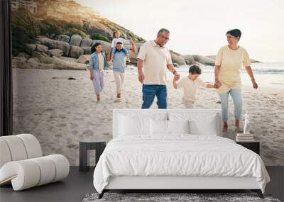 Holding hands, big family and walking at a beach for travel, vacation and fun in nature together. Freedom, parents and children relax with grandparents at the sea on holiday, trip or ocean adventure Wall mural