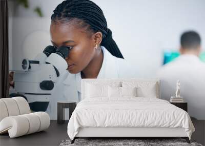 Medical science, black woman and microscope in laboratory for research, analytics and medicine. Woman, doctor and scientist study at work for an investigation, healthcare and futuristic mock up space Wall mural