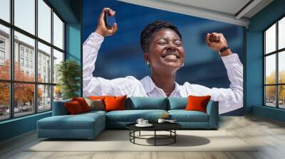 Winner, celebration and black woman in business happy after winning a corporate achievement outside in summer. Young African female worker excited, smile and hired after successful job promotion Wall mural