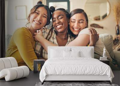 Portrait of a group of women, friends hug on sofa with smile and bonding in living room together in embrace. Hug, love and friendship, girls on couch with diversity, pride and people in home with fun Wall mural