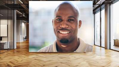 Smile, happy and portrait of a businessman in the office with confidence and positive attitude. Young, career and face headshot of professional African male designer standing in a modern workplace. Wall mural