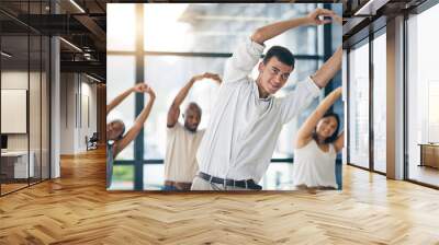 Team building, stretching and a team of business people in the office to workout for health or mobility together. Exercise, fitness and training with an employee group in the workplace for a warm up Wall mural