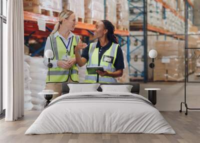 Women, tablet and partner in discussion at warehouse for logistics, cargo and team at global shipping company. People, touchscreen and talk with app for boxes, distribution or supply chain in factory Wall mural