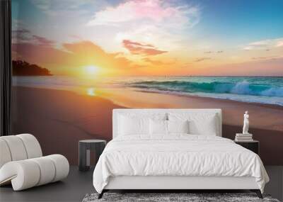 beach scene at sunrise symbolizing peace and recovery with gentle waves soft sand and a vibrant colorful sky reflecting on the water Wall mural