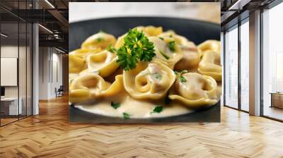 close up of tortellini in a creamy alfredo sauce sprinkled with parsley on dark plate blurred background Wall mural