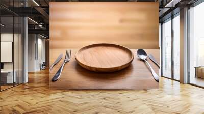 empty round wooden plate with spoonand fork on wood table Wall mural