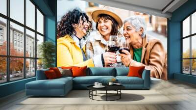 Three happy retired female drinking and toasting red wine glasses at bar restaurant - Group of happy elderly women having fun in the city - Concept about older friends smiling and laughing together Wall mural