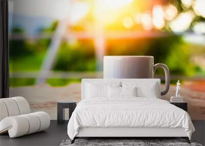 A cup of coffee on the table in the morning. Wall mural