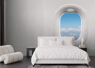 Isolated airplane window with blue sky Wall mural