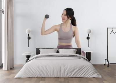 Isolated asian woman with dumbbell exercise on white background Wall mural