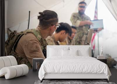 Soldiers have an operation plan meeting in a tent before the mission Wall mural