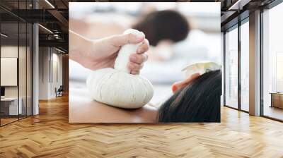 View of Woman Receiving a Herbal Compress Ball Massage on Her Back Wall mural