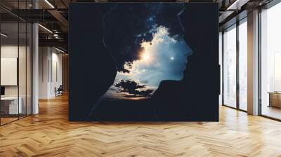 Silhouette of a man with a sky and sun inside his head, symbolizing hope and inner light. Wall mural