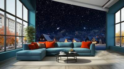 Snowy village under starry night sky Wall mural