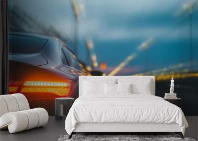 The automobile accelerates quickly at night. blurry road with lights while a fast-moving automobile is on it. Wall mural