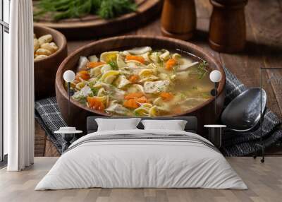 bowl of chicken noodle soup on a wooden table Wall mural