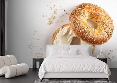 A delicious homemade new york city jewish deli style poppy sesame seed bagel with cream cheese both halves ready to eat isolated on white background with copy space Wall mural