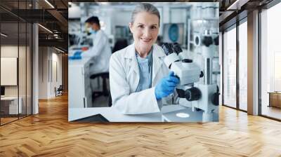 Microscope, scientist and portrait of senior woman in laboratory to review virus research, medical test and biotechnology. Science, microbiology and happy female professor planning expert assessment Wall mural