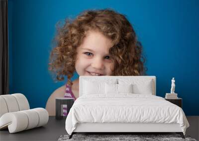 happy smiling laughing child: girl with curly hair Wall mural