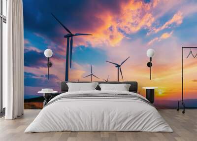 Wind farm at sunset with turbines silhouetted against the colorful sky, representing clean energy Wall mural