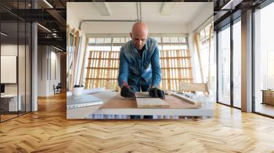 Caucasian carpenter preparing wooden furniture for customers showing handicraft carpentry concept Wall mural