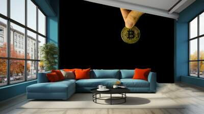 Human holding gold bitcoin photo on the simple color background with clipping path Wall mural