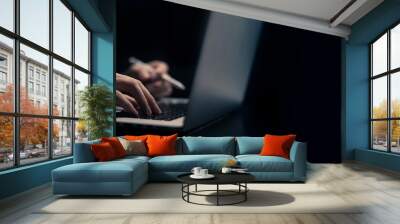 Businessman is working on Laptop. stock business or work from home concept. dark tone Wall mural