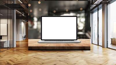 Laptop with blank screen on wood table in blurry background with house or office modern. nature orange bokeh and sunlight in morning. Wall mural