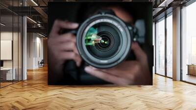 photographer  take pictures Snapshot with camera. man hand holding with camera looking through lens.Concept for photographing articles Professionally. Wall mural