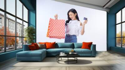 woman holding credit card and shopping bags. Wall mural