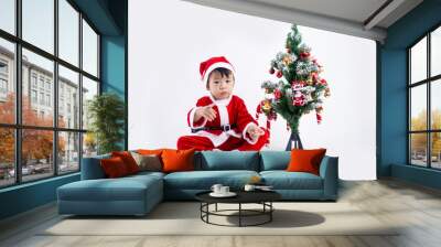 Asian boy is wearing a Santa costume to celebrate Christmas. White background Wall mural