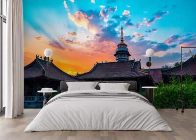 traditional Asian temple with ornate roofs and a large tower in the background against a colorful sunset sky created with generative ai Wall mural