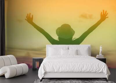 Silhouette of woman praying over beautiful sky background Wall mural