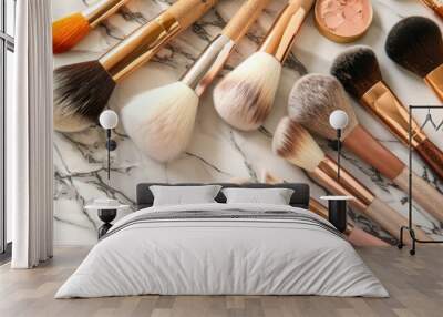 A variety of makeup brushes neatly arranged on a marble surface with soft light. Wall mural