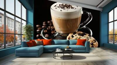 A cup of cappuccino with a chocolate chip cookie and coffee beans on a black background. Wall mural