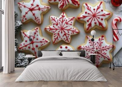 A festive arrangement of decorated cookies shaped like snowflakes and holiday motifs. Wall mural