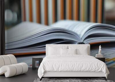 Open book with a graph visible on a desk with blurred bookcases in the background. Wall mural