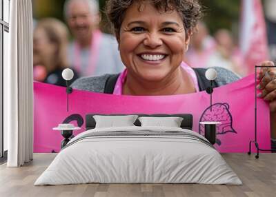 Smiling woman holding a pink sign that reads 'survivor' with a brain drawing. Wall mural