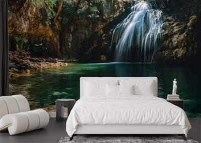 Tranquil waterfall cascading into a pristine pool. Wall mural