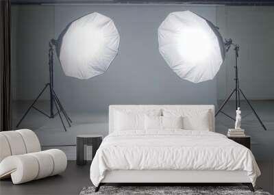 Two softboxes with white diffusers on tripods illuminating a white backdrop in a studio. Wall mural