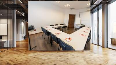 Conference room with benches, tables and a projector. Empty Conference Room In Modern Office. Interior of a classroom with white walls and wooden floor.  Office Business. Wall mural