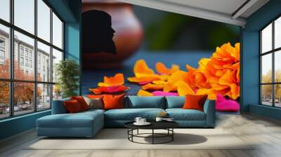 A vibrant display of orange flowers alongside a decorative pot, showcasing nature's beauty and color contrast in a serene setting. Wall mural