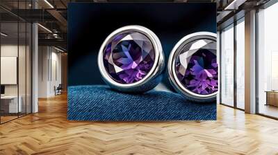 Stunning amethyst earrings gleam against a luxurious dark fabric backdrop, showcasing their vibrant purple hue and elegant silver settings. Wall mural