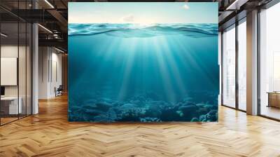 The ocean is calm and clear, with a bright sun shining through the water Wall mural