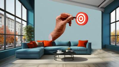 Hand holding a dart aiming at the target - business targeting, aiming. Art collage digital pop modern art. Wall mural