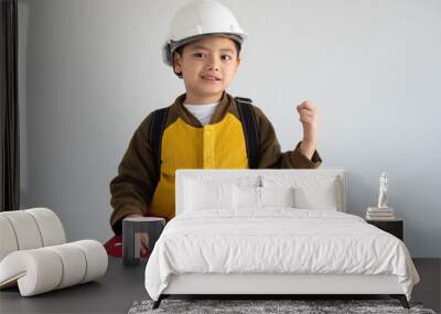 Asian boy with white engineer hat and whiting on the book education concept Wall mural