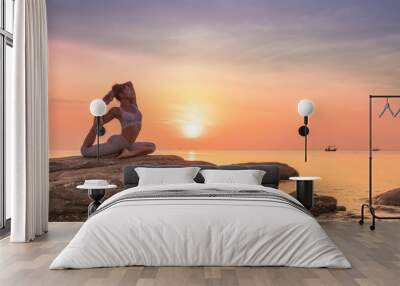 Asian girl practice Yoga on the beach Sunrise morning day Wall mural