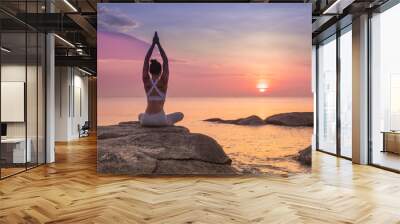 Asian girl practice Yoga on the beach Sunrise morning day Wall mural